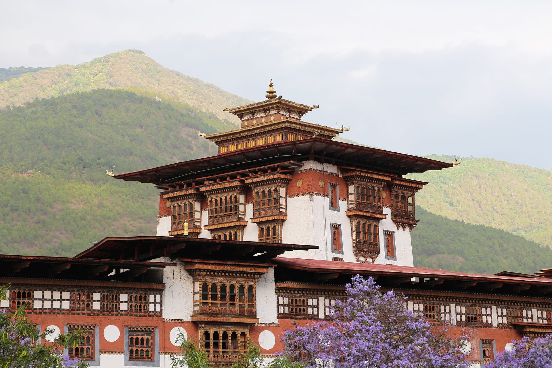 A whitewashed Bhutanese dzong fortress-monastery above a river valley