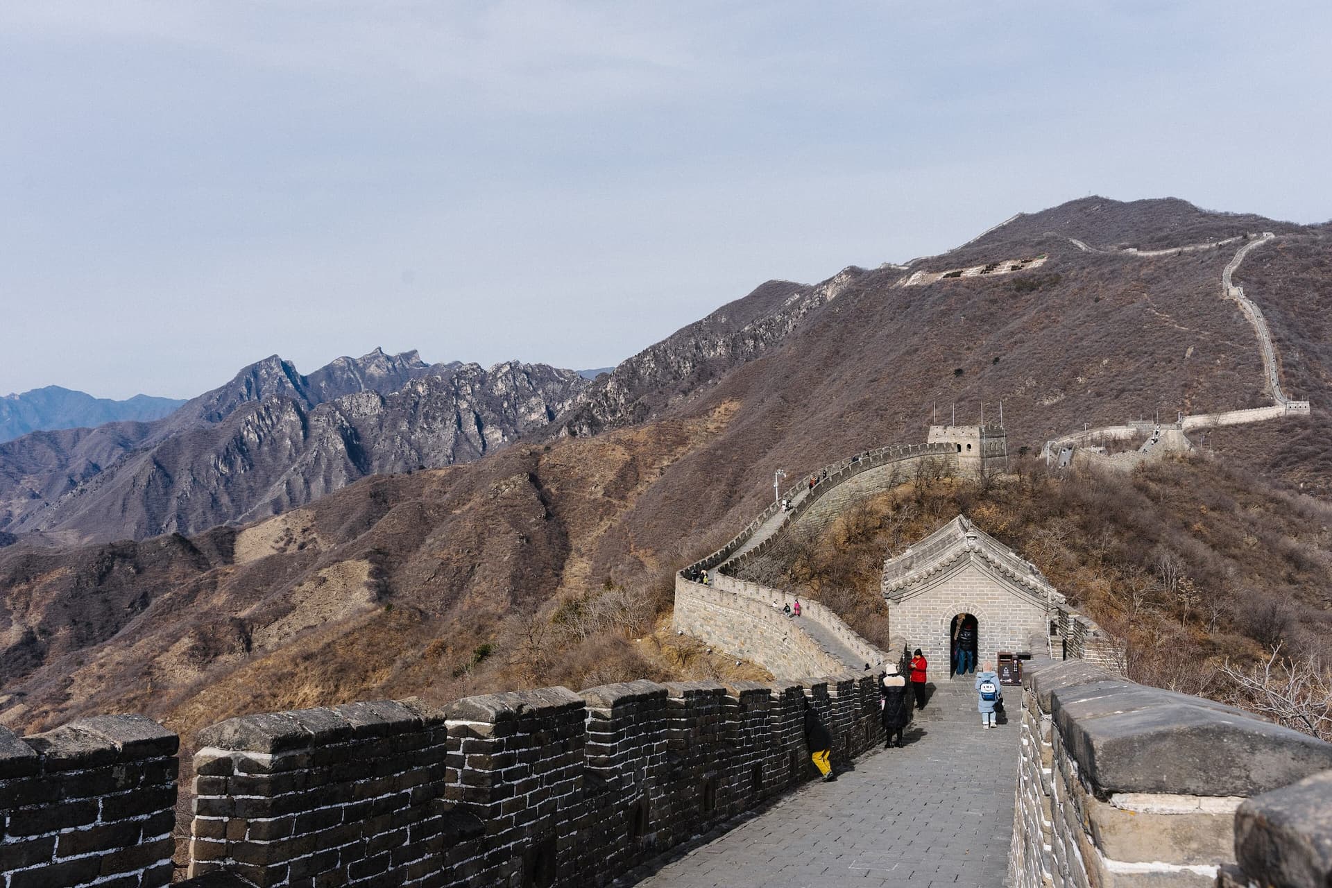 The Great Wall of China snaking over forested ridgelines near Beijing