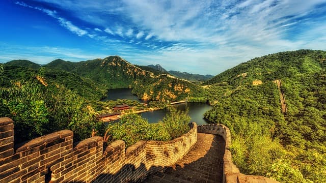 The Great Wall of China snaking over forested ridgelines near Beijing