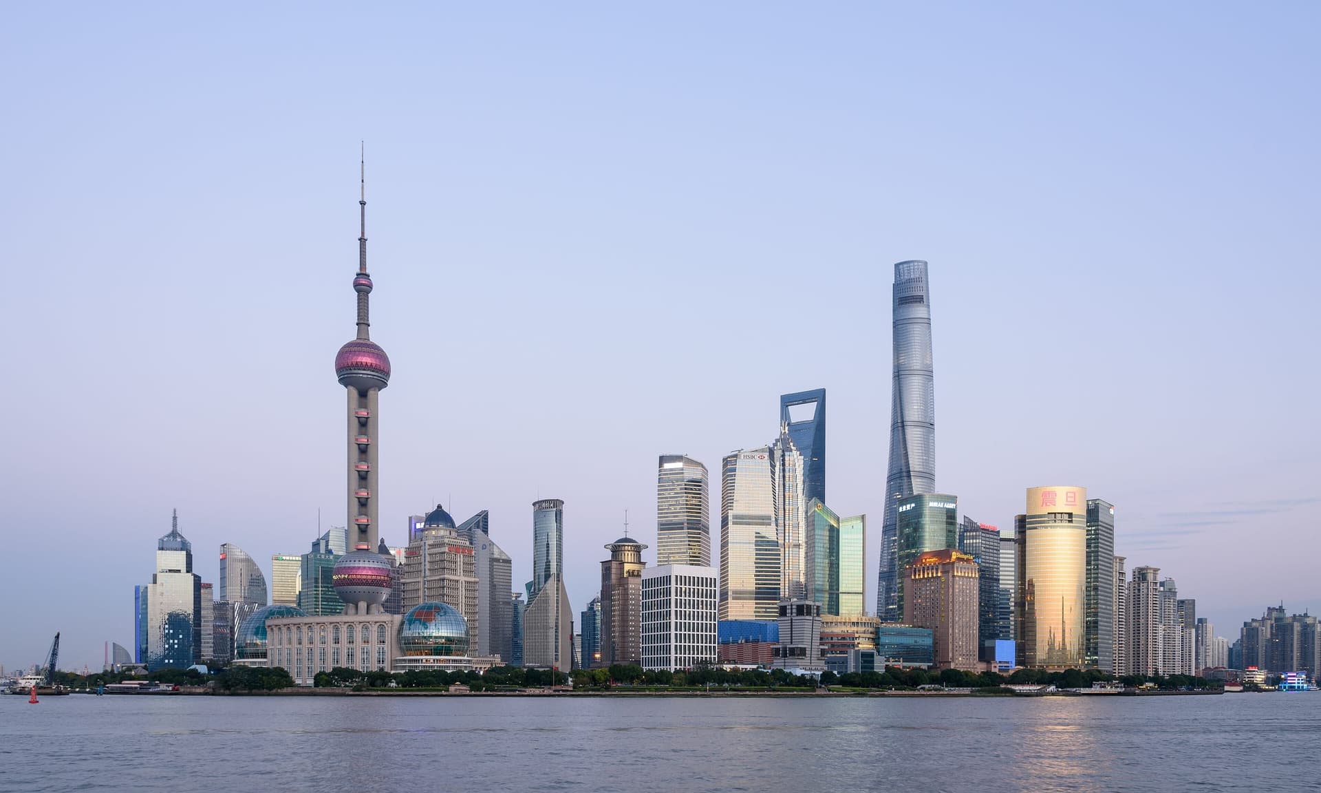 The illuminated skyline of Shanghai's Pudong district across the Huangpu River