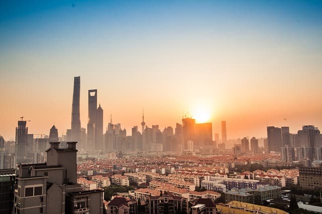 The illuminated skyline of Shanghai's Pudong district across the Huangpu River
