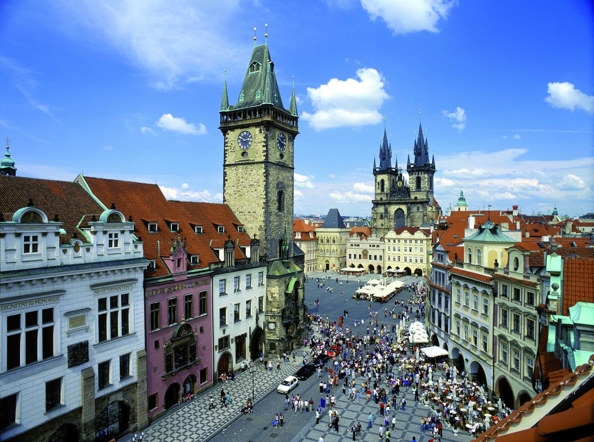 A classic European cityscape of domes, rooftops and river bridges