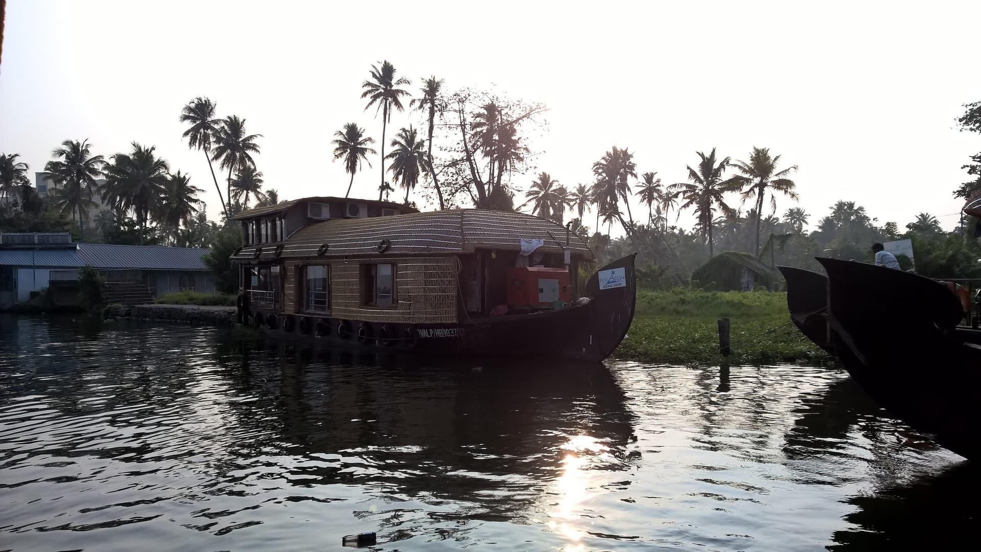 A traditional houseboat on the Kerala backwaters at golden hour