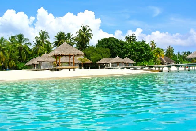 Clear turquoise lagoon and white-sand beach of a Maldives atoll