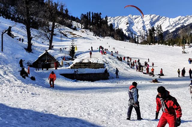 Snow-dusted Himalayan peaks rising above the pine forests around Manali in Himachal Pradesh