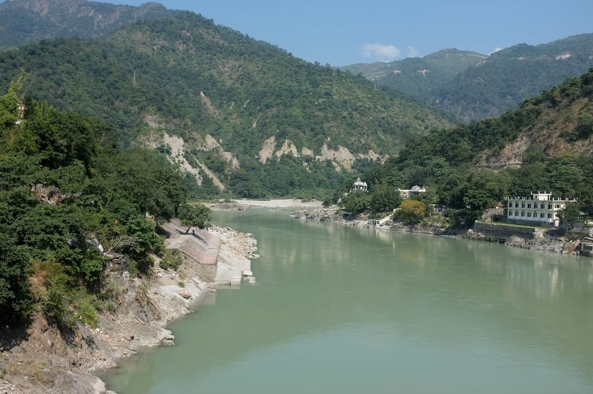 The Ganges flowing between forested Himalayan foothills at Rishikesh