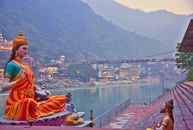 The Ganges flowing between forested Himalayan foothills at Rishikesh
