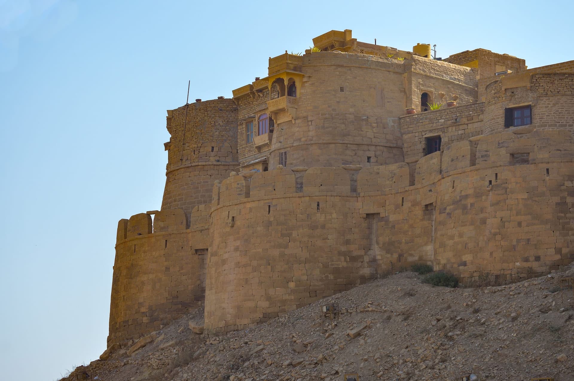 Golden sandstone ramparts of Jaisalmer rising from the Thar Desert
